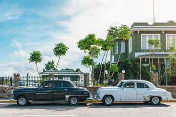 Classic Cars parked in the street.