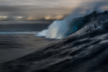 Beautiful dark ocean wave breaking at Fiji islands. Motion blur effect. Long Exposure Shot