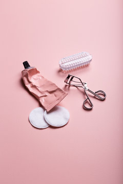 Pastel pink and white beauty objects color blocked on a pink background