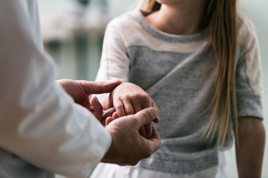 Exam: Doctor Works On Sprained Wrist On Girl Patient