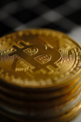 Stack of bitcoins with a single coin facing the camera