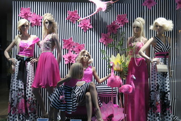 showcase with fashionable clothes of pink and black and white colors