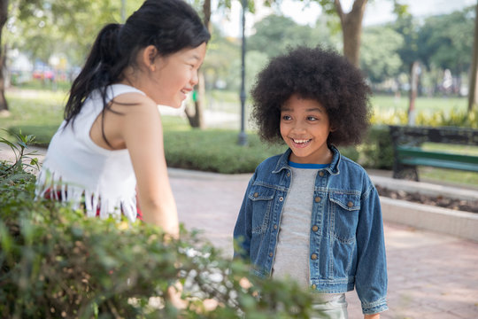 Two girls talking in a park
