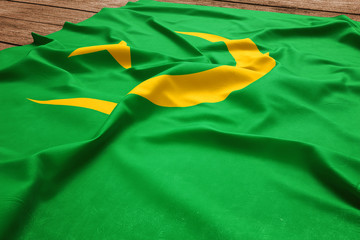 Flag of Mauritania on a wooden desk background. Silk Mauritanian flag top view.