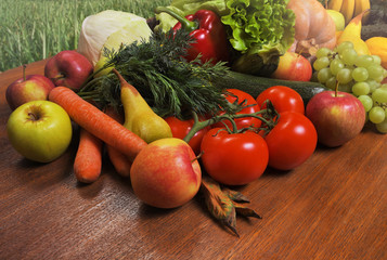 Various fresh vegetables and fruits on a wooden oak table