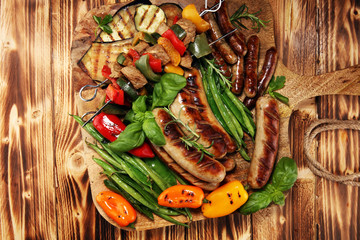 Assorted delicious grilled meat with vegetable on a barbecue. Grilled pork shish or kebab on skewers with vegetables . Food background shashlik