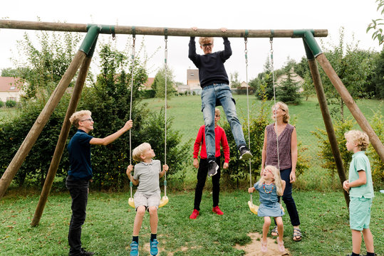 mother with 6 kids by swing set