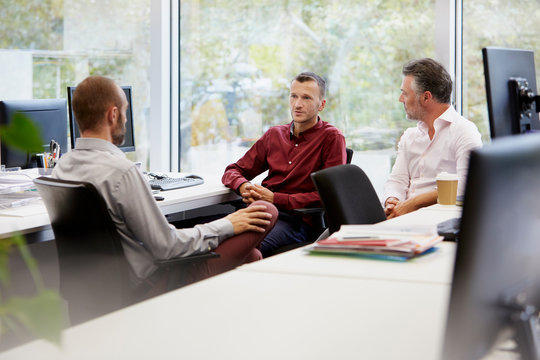 Mature Businessmen Discussing At Office