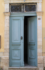 Open front door in stone wall