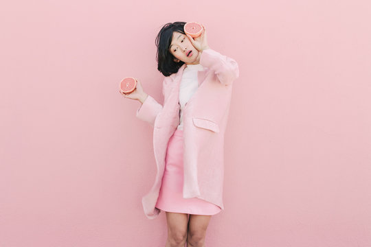 Girl in pink with grapefruit