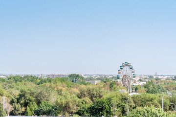 Fototapeta na wymiar A Ferris Wheel outside the Famous Itchan Kala Old Town in Khiva, Uzbekistan