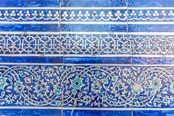 Tiles on a Wall of an Uzbek Madresah in Khiva, Uzbekistan. The beautifully crafted tiles are a signature feature of Uzbek architecture.