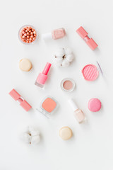 make-up accessories, fashion stylish cosmetics and macaroon on white desk background top view