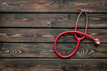 Stethoscope for family doctor set on wooden background top view space for text