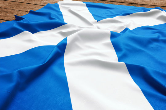 Flag of Scotland on a wooden desk background. Silk Scottish flag top view.