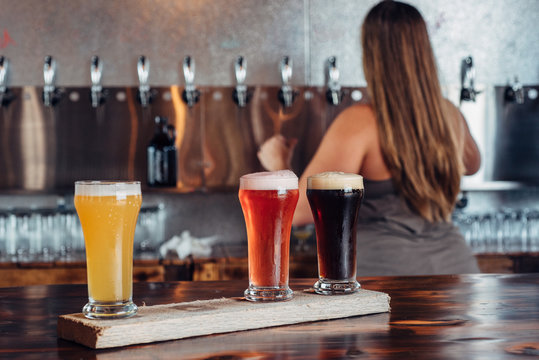 Bartender serving a flight of craft beer
