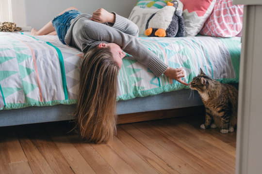 teen girl in bedroom with her cat, fun moment