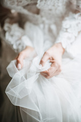 Young woman posing in a white wedding dress close up