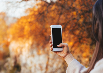 Female hand holding a phone, black screen