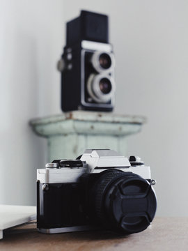 two vintage film cameras with background blur and grain