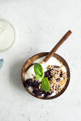 Oatmeal crumble in cast iron pan with fresh blueberry and natural yogurt. Healthy food concept. 