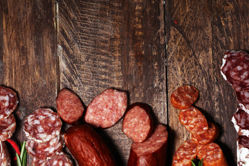 cold meat assortment with delicious salami and  fresh herbs . Variety of meat products including coppa and sausages
