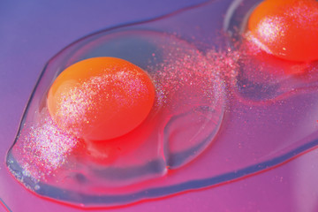 Two cracked uncooked eggs