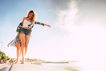 Group of people caucasian beautiful young females girls walking together in balance enjoying the outdoor leisure activity in friendship - holiday summer vacation concept
