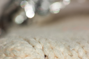 Delicate knitted fabric background with bokeh
