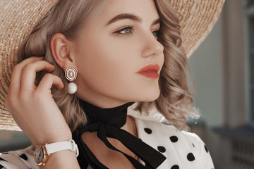Outdoor close up fashion portrait of young beautiful lady wearing  trendy pearl earrings, stylish...