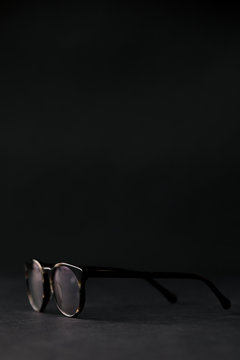 Glasses in a black setting