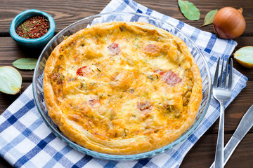 Rustic large tart with cloth on a wooden table, view from above, close-up