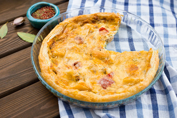 Rustic large tart with cloth on a wooden table, view from above, close-up