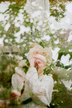 Double exposure of girl taking photo of tree
