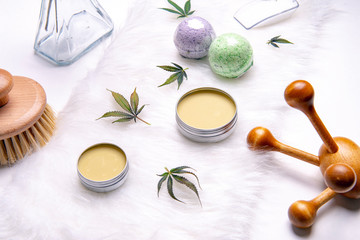 Assortment of cannabis topicals with bath bombs and marijuana salve over white