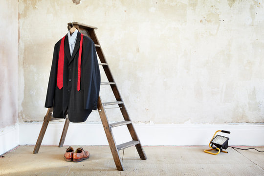 Suit, shirt and a tie in an empty room