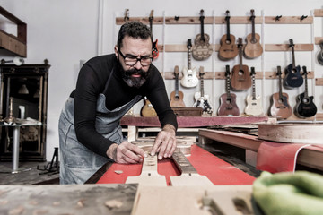 Guitar luthier working in his workshop