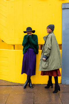 Direct view of women in winter clothes chatting in aisle