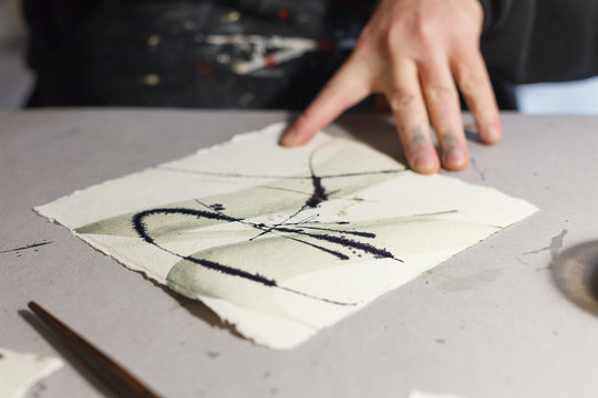 A calligrapher creating artworks in his workshop