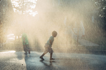 Kids playing in summer rain