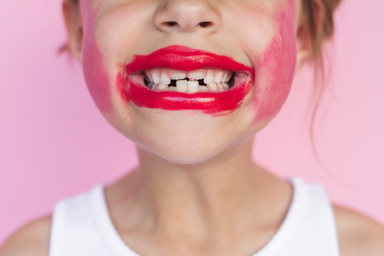 Girl With Lipstick On Her Teeth With A Huge Grin On Her Face