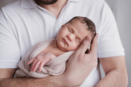 Sleeping baby in her father's arms