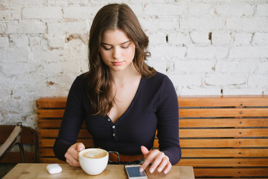Young woman listening to music on bluetooth headset