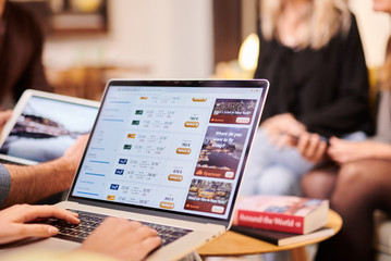 Incognito looking for cheap tickets to New York on laptop.