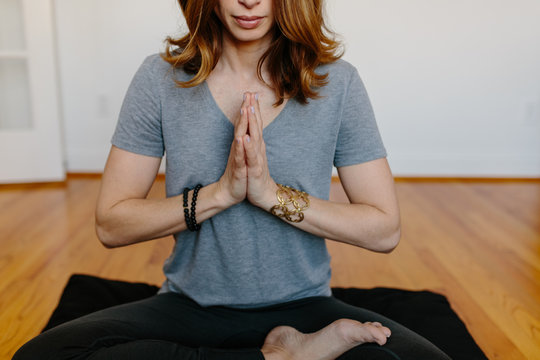 Beautiful woman practicing meditation at home