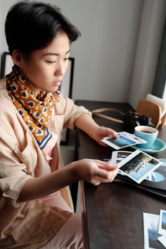 Traveller looking through photo prints