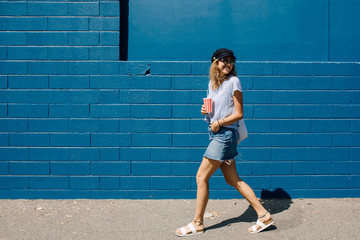 Smiling young woman walking on street