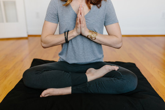 Beautiful woman practicing meditation at home