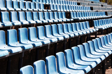 Empty blue seats on stadium background
