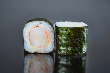 Classical roll sushi with crab sticks on black background for menu. Japanese food